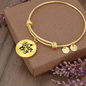 Bangle bracelet with circle pendant and quote Dream Big, gold