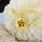 Bangle bracelet with circle pendant and quote Dream Big, gold