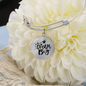 Bangle bracelet with circle pendant and quote Dream Big, stainless steel